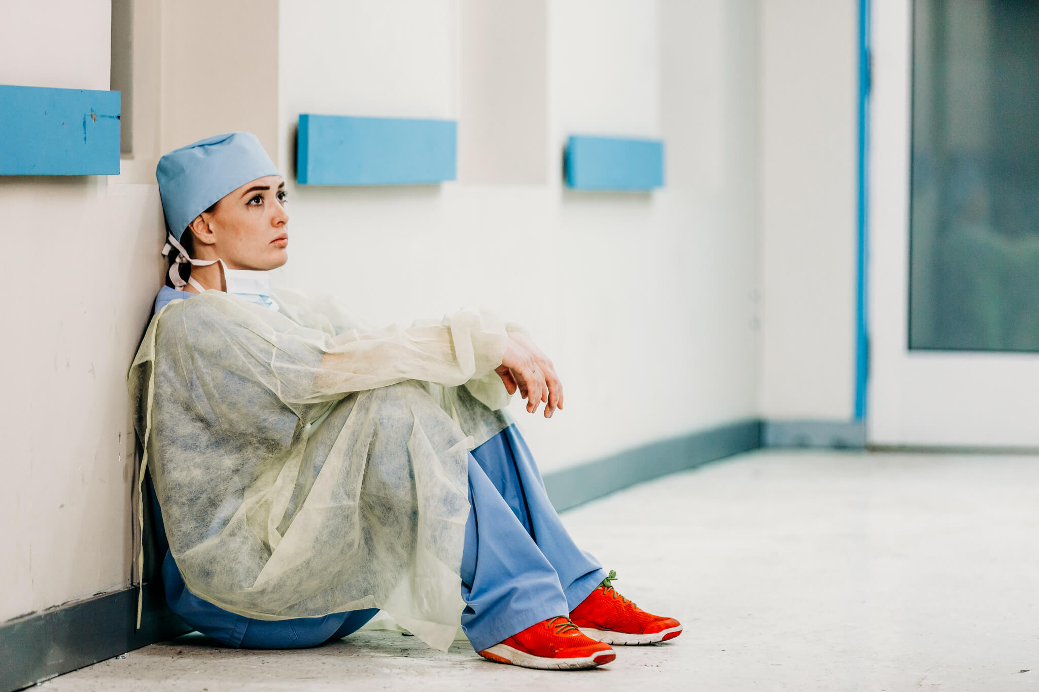 medical resident sitting on the floor in a hospital